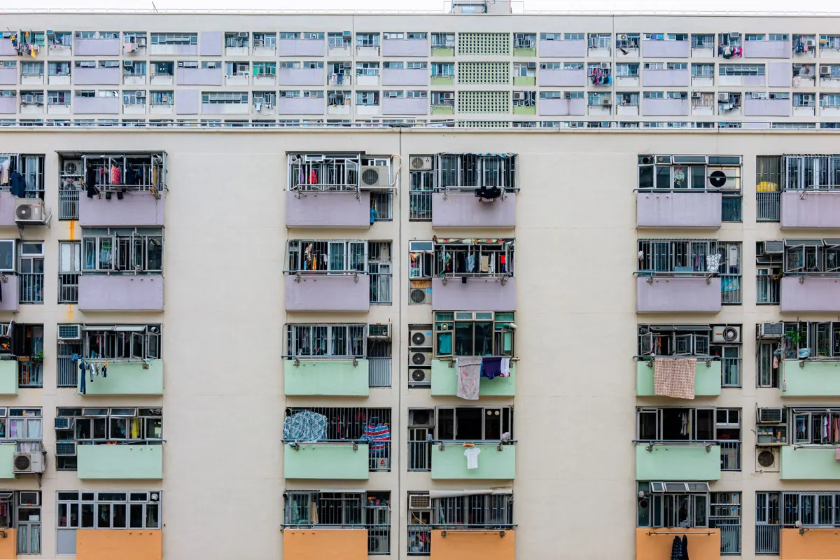 Tall apartment complex with rows of balconies