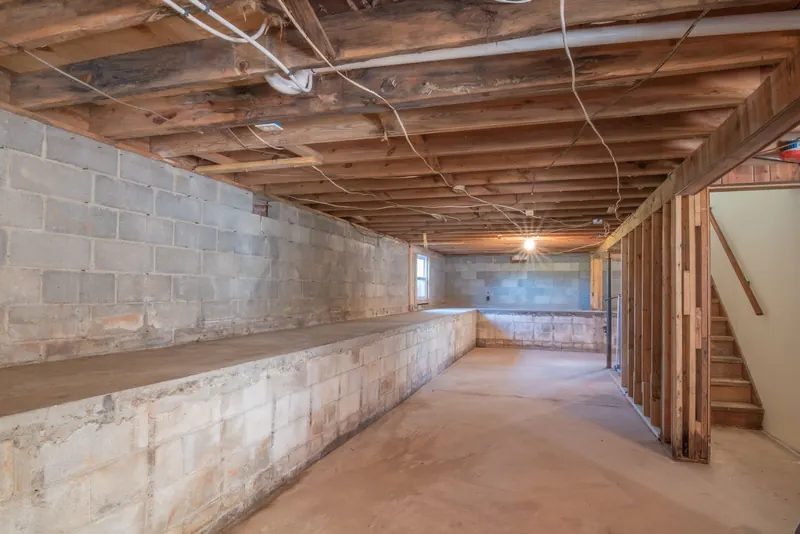 Basement with concrete block walls and exposed wooden joists