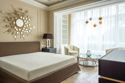 Bright finished bedroom with a white bed and large windows